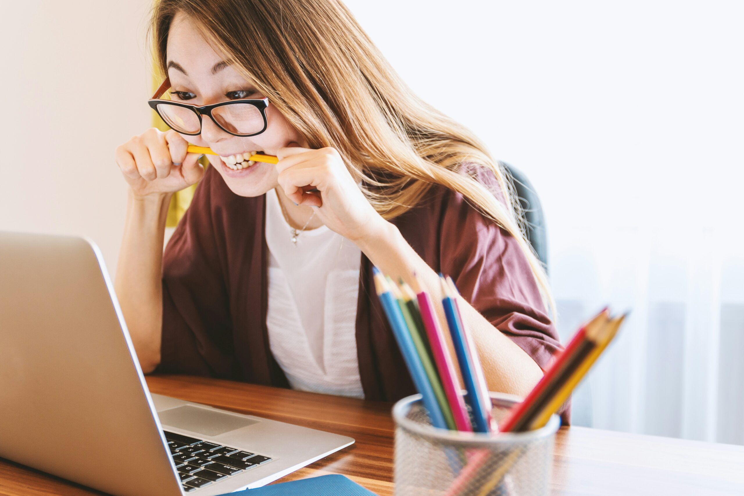 Transfer Learning: Accelerating Model Training with Pretrained Networks woman biting pencil while sitting on chair in front of computer during daytime